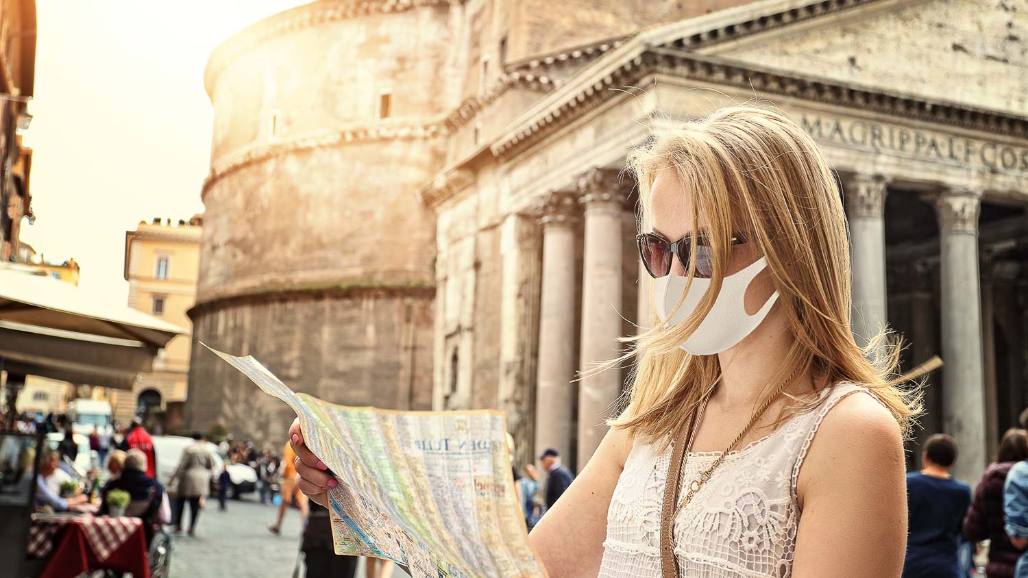 tourist with map visiting rome with mask on after covid 19