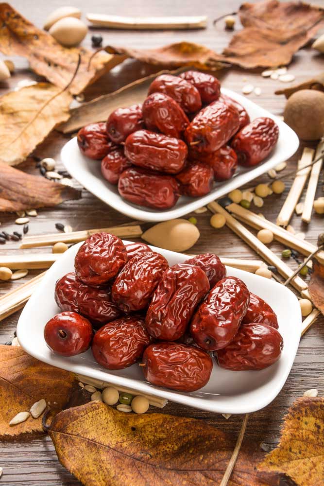 suve jujubes with yellow leaves wooden background