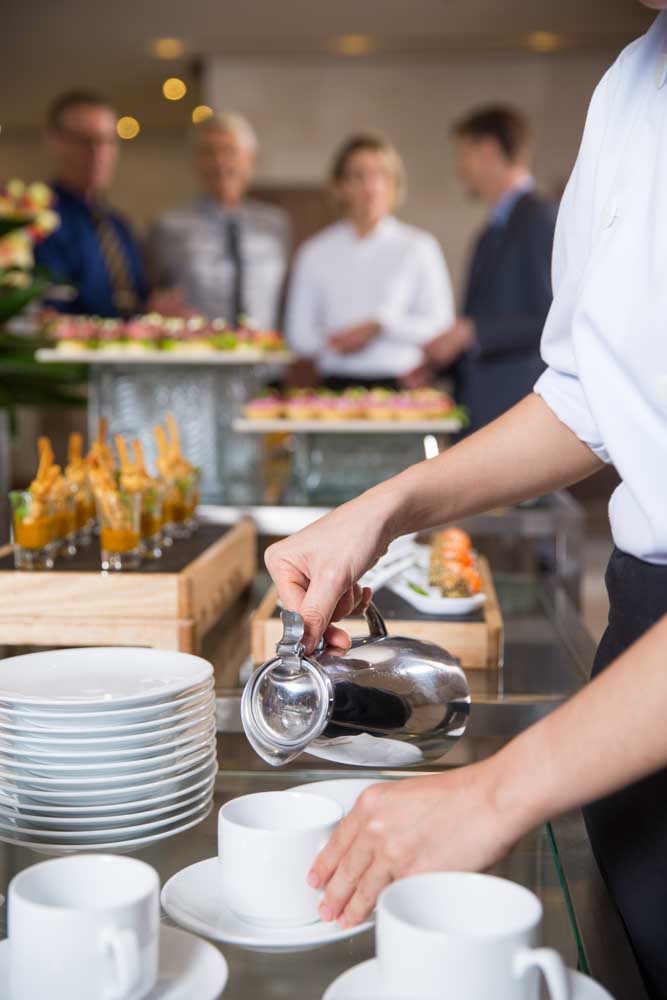 waitress serving coffee buffet restaurant