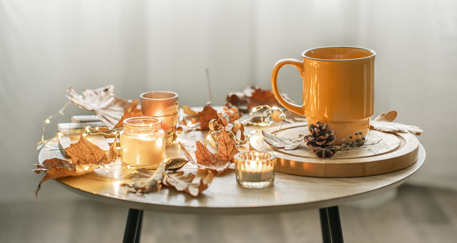 cozy composition with cup candles autumn leaves interior