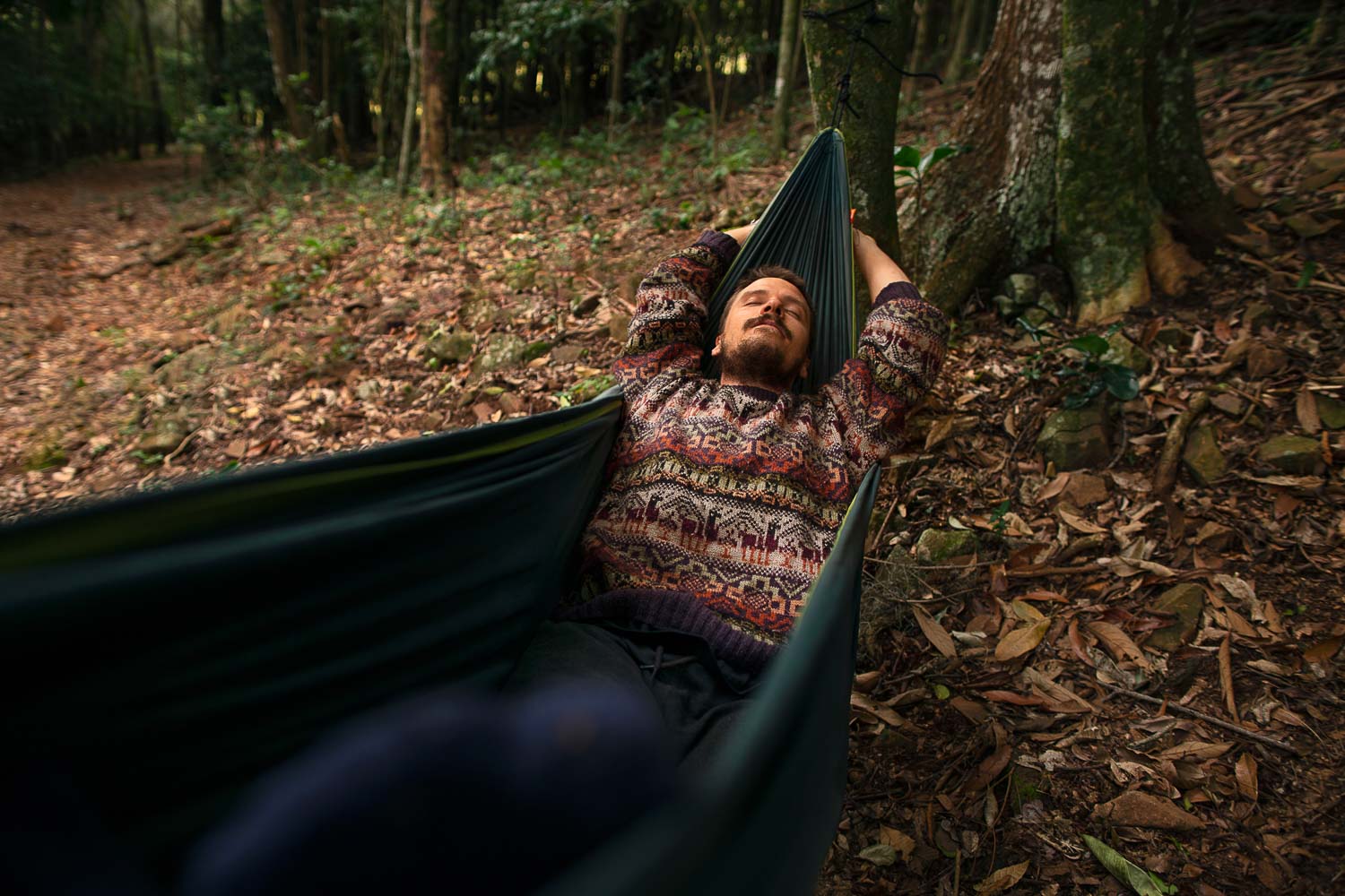 high angle adventurous man bivouacking